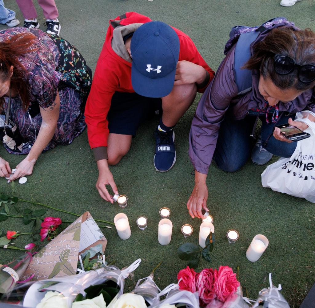 Children light candles at the crime scene